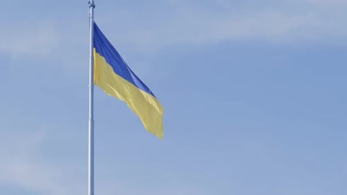 Ukrainian Flag Waving Proudly Against Blue Sky