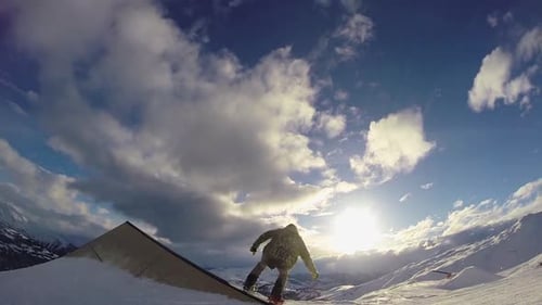 A young man snow boarding.