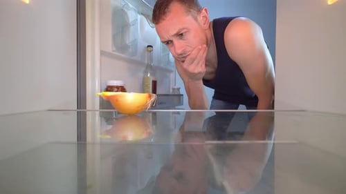 Man Looks Into Empty Refrigerator