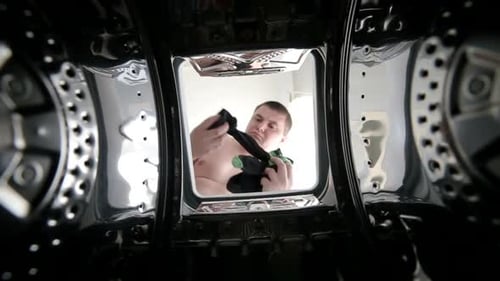 Inside Washing Machine Man Puts Clothes In