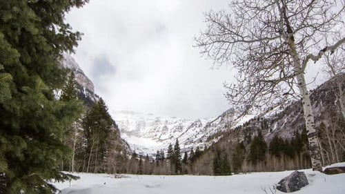 Time lapse of winter landscape as clouds move across the sky.