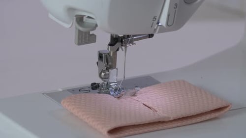 Hands preparing a fabric for sewing