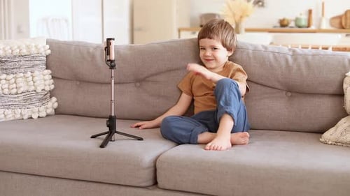 Happy Boy Video Calling at Home on Couch