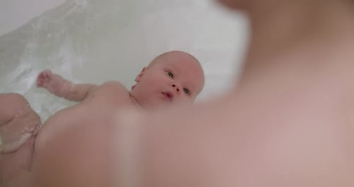 Infant Floating in Bathtub Close Up