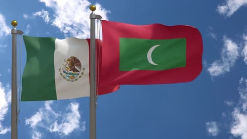 Flags of Mexico and Maldives Waving Against Blue Sky