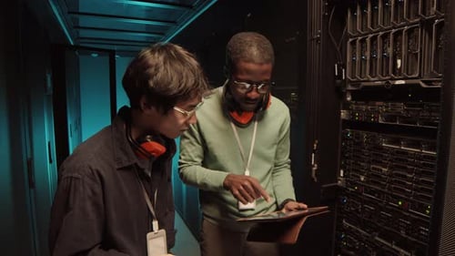 Data Specialists Working in Modern Server Room