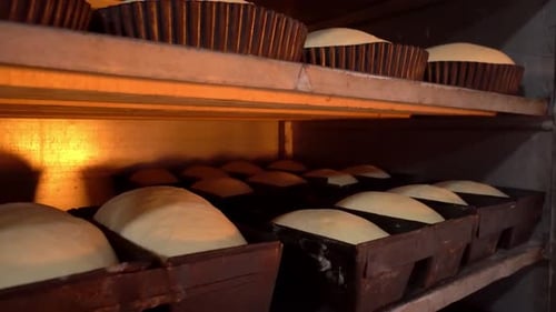 Jars for loaves of raw bread in bakery