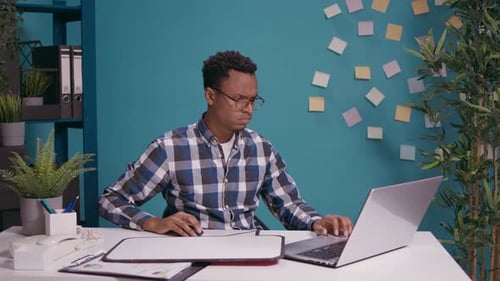 Man Holding Sign At Desk Needing Assistance