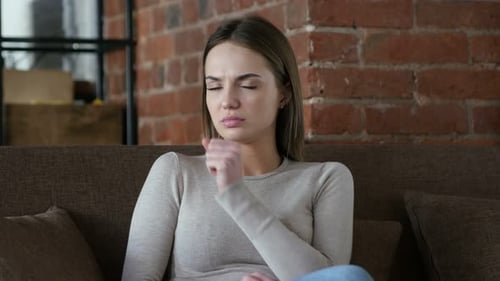 Woman with Cold Symptoms Coughing at Home
