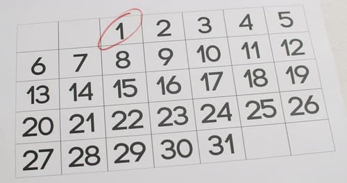 Hand Circles Dates on Calendar with Marker