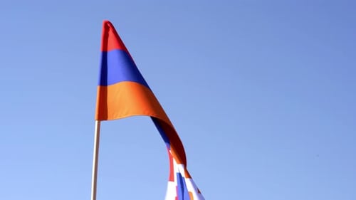 Waving Flag of Artsakh Against a Clear Blue Sky