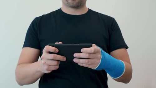 Adult Using Phone With Blue Wrist Cast