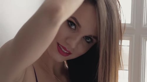 Beautiful Young Woman Smiles Confidently in Close Up