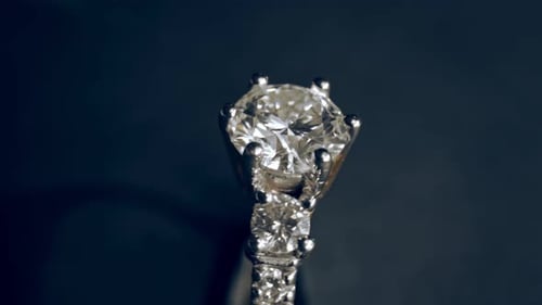 Extrem detaillierte Nahaufnahme des Diamantrings beim Rotieren auf dunklem Hintergrund
