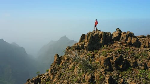 The Man Standing on a Mountain Top