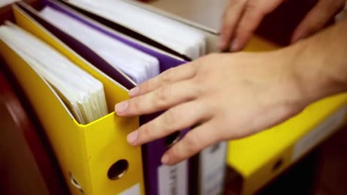 Office worker finding a folder in the archive