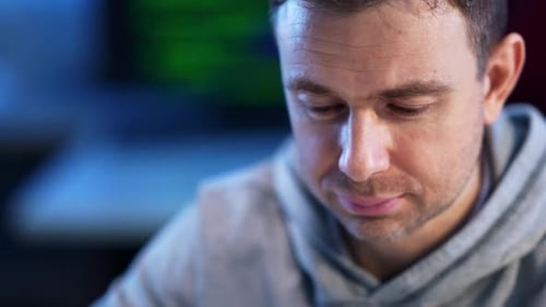 Closeup Face of Confident Concentrated Caucasian Programmer Coder Typing on Keyboard Coding