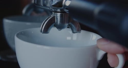Espresso Pouring into White Coffee Cup Close-up