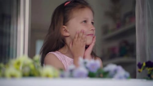Little Girl Child In Window At Home During Coronavirus Pandemic