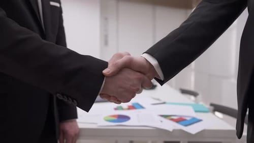 Closeup Handshake of Two Caucasian Businessmen in Office Indoors