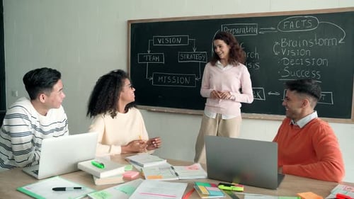 Four Multiracial Cheerful Happy Colleagues Working Together in Modern Office