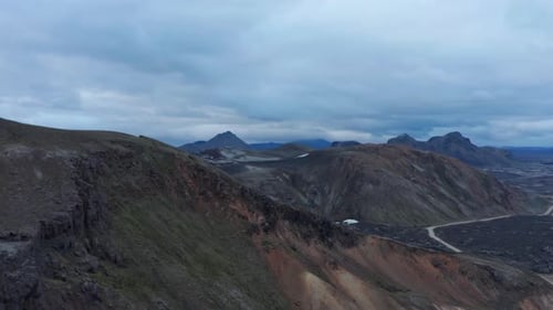 Aerial Descending Footage on Rugged and Eroded Slope of Mountain Ridge