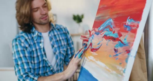 Young Adult Male Painting Abstract Art with Hands