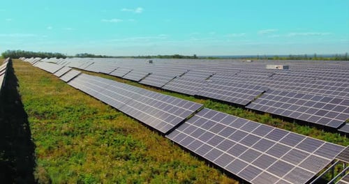 Aerial View of Solar Panel Field on Sunny Day