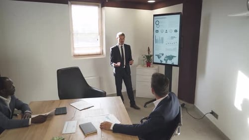 Business Meeting in Office, Young Businessman Speak at a Meeting and Shows Financial Infographic