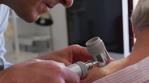 Medical Check-up: Doctor Examines Patient's Back with Dermatoscope