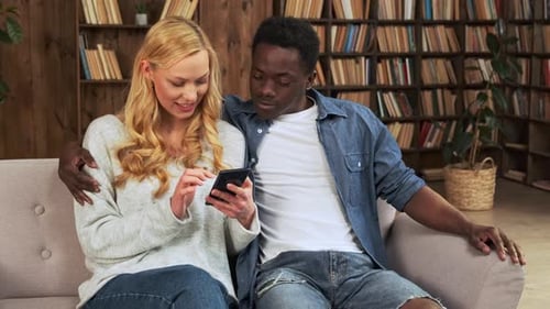 Couple Relaxing at Home With Mobile Phone