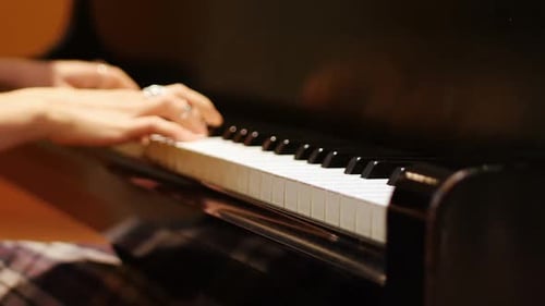 Woman Plays Beautiful Music on Piano