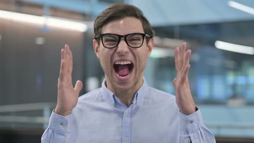 Man Screaming With Frustration in Office Setting
