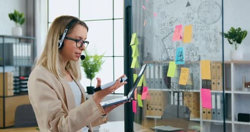 Woman Giving Presentation in Modern Office Environment