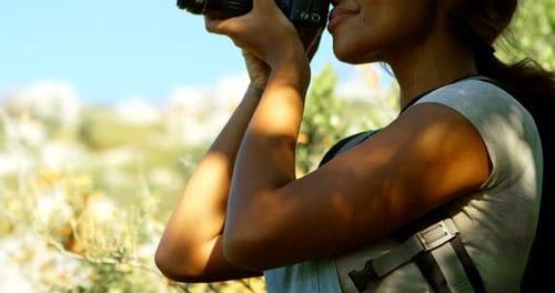 Woman Taking Photos with Camera in Natural Field