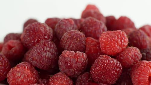 Eco bright colorful berry raspberry rotates 360 on a white background. Close-up of loose raspberry