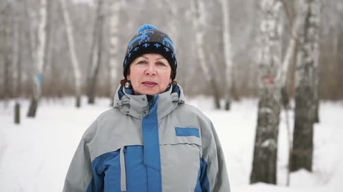 Portrait Of a Smiling Mature Woman In The Forest In Winter