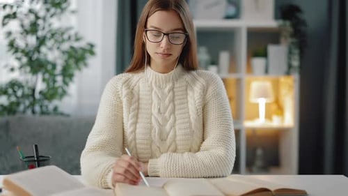 Woman Studying and Smiling in Home Environment