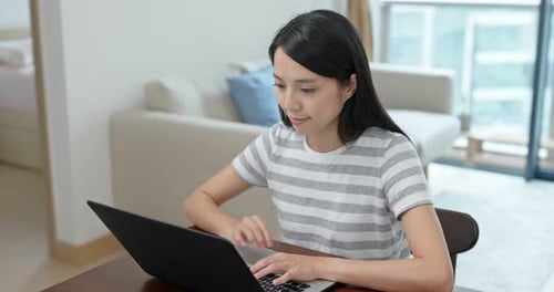 Woman Using Laptop Computer at Home