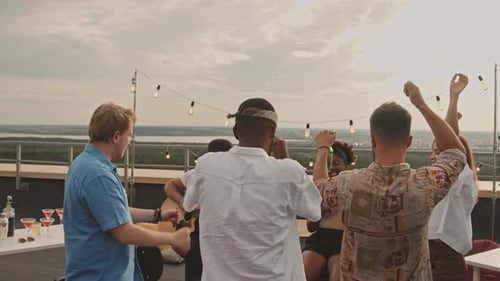 Friends Celebrate with Music at Rooftop Party