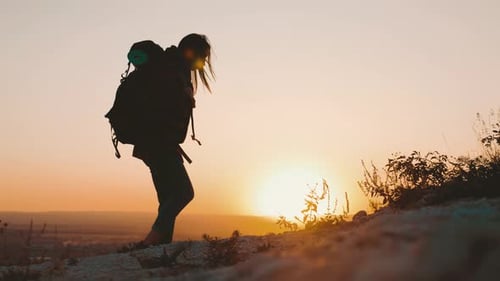Woman Hiking With Backpack at Sunrise