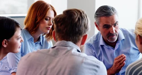 Diverse Team Discussing Business in Bright Workplace