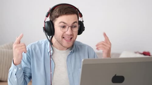 Energetic Young Adult Using Computer and Headset