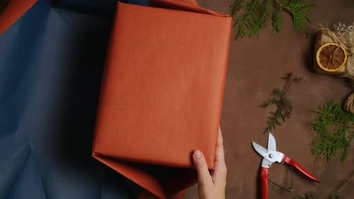 Wrapping a Christmas Gift with Orange Paper