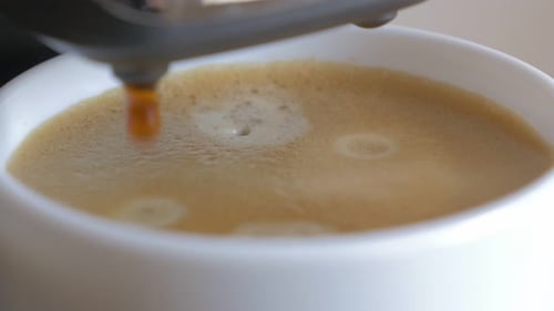 Coffee Machine Brewing Espresso into a Mug
