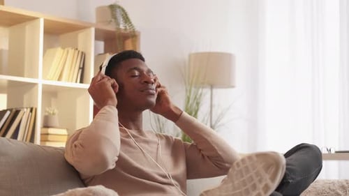 Man Relaxing at Home Listening to Music