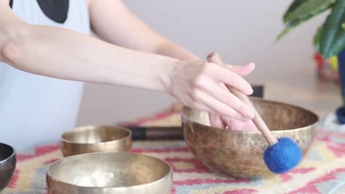 Woman Playing Singing Bowl For Meditation and Relaxation