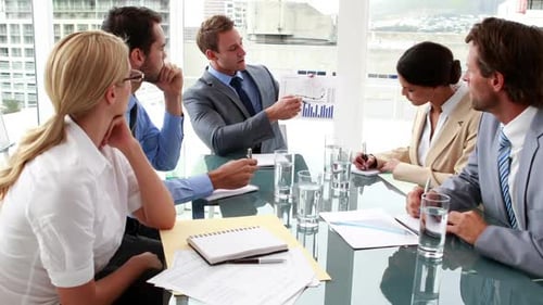Business manager showing his staff data at a meeting