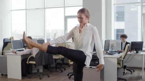 Caucasian Businesswoman Exercising in Office