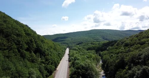 Aerial View of a Rural Highway Between Mountains